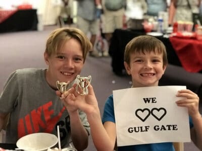 Gulf Gate Kids Holding Trophies And A We Love Gulf Gate Sign